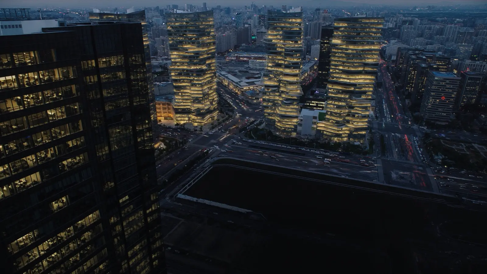 A modern financial district skyline at blue hour